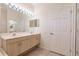 Bathroom boasts a double vanity with a large mirror and an adjacent door at 2970 Royal Palm Dr, North Port, FL 34288