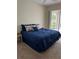Spacious bedroom with a king-size bed and sliding glass doors leading to a patio at 2970 Royal Palm Dr, North Port, FL 34288