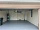 Attached garage with painted floor, water heater and extra storage at 2970 Royal Palm Dr, North Port, FL 34288