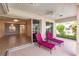 Relaxing lanai with tiled floor and comfy lounge chairs, offering access to the home's interior at 2970 Royal Palm Dr, North Port, FL 34288