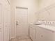 Bright laundry room with washer, dryer, and ample storage at 2970 Royal Palm Dr, North Port, FL 34288