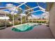Inviting kidney-shaped pool and spa with a screened enclosure at 2970 Royal Palm Dr, North Port, FL 34288