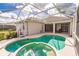 Enjoy this relaxing pool and spa with screened enclosure at 2970 Royal Palm Dr, North Port, FL 34288