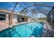 Enjoy this gorgeous screened pool and spa with a view of the lush landscape at 243 Fairway Rd, Rotonda West, FL 33947