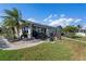 The backyard features a stone patio, seating and manicured grass and landscaping at 440 Norma Ct, Punta Gorda, FL 33950