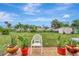 Relaxing backyard patio with potted plants and view of homes at 4555 Mckibben Dr, North Port, FL 34287