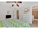 Bright bedroom with tiled floors, double doors, and a ceiling fan at 4555 Mckibben Dr, North Port, FL 34287