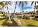 Landscaped backyard with a stone pathway leading to a private dock at 3600 Aruba Ct, Punta Gorda, FL 33950