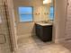 Bathroom with granite countertop vanity and a walk-in shower at 10225 Winnipeg St, Port Charlotte, FL 33981