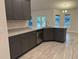Modern kitchen with an island, dark cabinets, and granite countertops at 10225 Winnipeg St, Port Charlotte, FL 33981