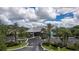 Aerial view of community clubhouse with palm trees and parking lot at 19310 Water Oak Dr # 201, Port Charlotte, FL 33948