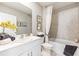Clean bathroom with white vanity, bathtub, and shower at 5096 Schubert Trl, North Port, FL 34287