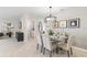 Elegant dining room with chandelier, glass top table, and six chairs at 5096 Schubert Trl, North Port, FL 34287
