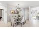 Elegant dining room with chandelier, glass table, and neutral-toned chairs at 5096 Schubert Trl, North Port, FL 34287