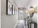 Bright entry hall with tile flooring, console table, and framed art at 5096 Schubert Trl, North Port, FL 34287