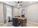 Home office with L-shaped desk and two chairs at 5096 Schubert Trl, North Port, FL 34287