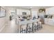 Modern kitchen with stainless steel appliances, central island with bar stool seating, and white cabinets at 9572 Turtle Grass Cir, Punta Gorda, FL 33950