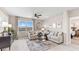 Spacious living room features a large window with water view, comfortable seating, and a ceiling fan at 9572 Turtle Grass Cir, Punta Gorda, FL 33950