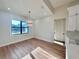 Light-filled dining room with hardwood floors and chandelier at 2925 Woodward Ave, North Port, FL 34286