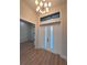 Modern entryway with double doors and a stylish light fixture at 2925 Woodward Ave, North Port, FL 34286