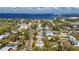 Aerial view of a teal home with a gray roof, located in a tree-lined neighborhood at 350 Gill St, Punta Gorda, FL 33950