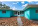 Teal house exterior with walkway and landscaping at 350 Gill St, Punta Gorda, FL 33950