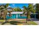 Teal single story house with palm trees at 350 Gill St, Punta Gorda, FL 33950