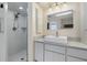 Bathroom featuring a walk-in shower and single vanity with a large framed mirror at 3936 Crooked Island Dr, Punta Gorda, FL 33950