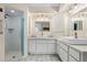 Bright bathroom featuring a glass-enclosed shower and dual vanities with modern fixtures at 3936 Crooked Island Dr, Punta Gorda, FL 33950