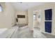 Spacious bathroom featuring a jacuzzi tub, dual vanity sinks, and tiled floors at 3936 Crooked Island Dr, Punta Gorda, FL 33950