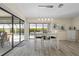 Bright dining area with views of the pool and surrounding greenery from sliding glass doors at 3936 Crooked Island Dr, Punta Gorda, FL 33950