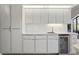 Bright kitchen with white cabinets, stainless steel appliances, and a beverage cooler at 3936 Crooked Island Dr, Punta Gorda, FL 33950