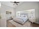 This is a primary bedroom featuring wood floors, a ceiling fan, and white walls at 86 Zenith St, Port Charlotte, FL 33954