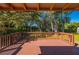 Wooden deck overlooking a backyard with lush trees at 1327 Abscott St, Port Charlotte, FL 33952