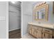 Bathroom with vanity, sink, mirror, and walk-in closet at 1327 Abscott St, Port Charlotte, FL 33952