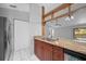 Open kitchen with granite countertops, stainless steel appliances and wood cabinets at 1327 Abscott St, Port Charlotte, FL 33952