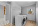 Laundry room with washer, dryer, and storage shelves at 1327 Abscott St, Port Charlotte, FL 33952