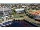Aerial view shows waterfront property with pool, private boat dock, and lush landscaping, a boater's dream at 2501 Rio Largo Ct, Punta Gorda, FL 33950