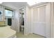 Well-lit bathroom featuring floral wallpaper, patterned flooring, and a shower at 2501 Rio Largo Ct, Punta Gorda, FL 33950