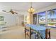 Dining room featuring a ceiling fan and large windows, creating a comfortable and inviting atmosphere at 2501 Rio Largo Ct, Punta Gorda, FL 33950