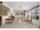 Bright living room with large windows, two recliners, built in shelves, and Terrazzo flooring at 2501 Rio Largo Ct, Punta Gorda, FL 33950
