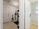 View into the mud room and into a half-bath with floral wallpaper at 2501 Rio Largo Ct, Punta Gorda, FL 33950