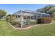 Enclosed pool with neat landscaping and a small garden, adjacent to the home at 2501 Rio Largo Ct, Punta Gorda, FL 33950