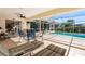 Enclosed pool patio featuring lounge chairs, ceiling fan, and outdoor dining furniture overlooking the inviting pool at 2501 Rio Largo Ct, Punta Gorda, FL 33950