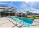 Sparkling pool with handrails, screened enclosure, and meticulously maintained landscaping for ultimate relaxation at 2501 Rio Largo Ct, Punta Gorda, FL 33950