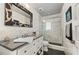 Modern bathroom with a large walk-in shower and dark vanity at 5117 Collingswood Blvd, Port Charlotte, FL 33948