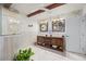 Bathroom boasts double sinks, wood vanity, and decorative tile at 5117 Collingswood Blvd, Port Charlotte, FL 33948