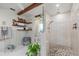 Large bathroom with walk-in shower, mosaic flooring and wood shelving at 5117 Collingswood Blvd, Port Charlotte, FL 33948