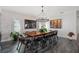 Elegant dining room with large wood table and modern black chairs at 5117 Collingswood Blvd, Port Charlotte, FL 33948