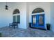 Elegant entryway with blue double doors and a sitting bench at 5117 Collingswood Blvd, Port Charlotte, FL 33948